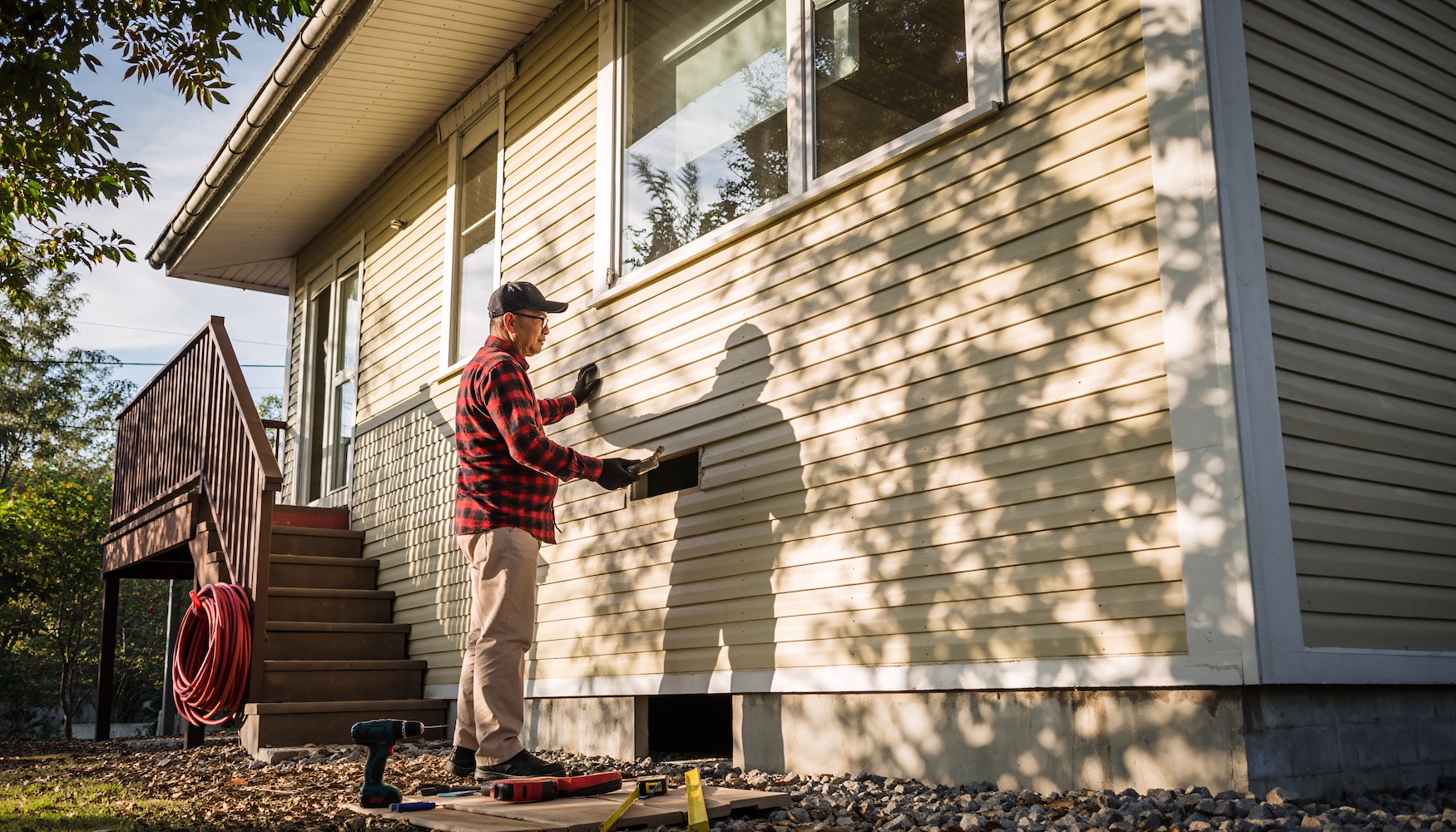 Exterior contractor performing siding repair